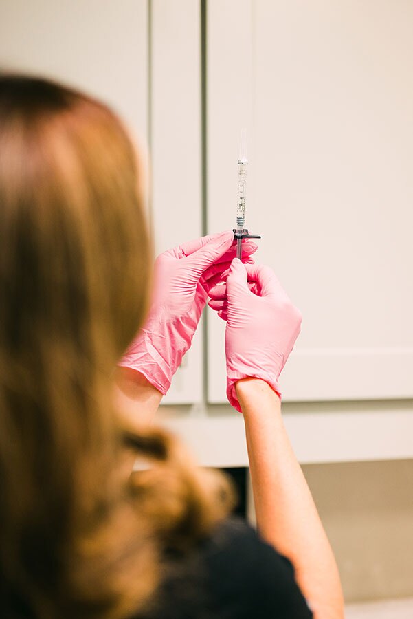 Staff member of Gulf Coast Plastic Surgery Holding Syringe